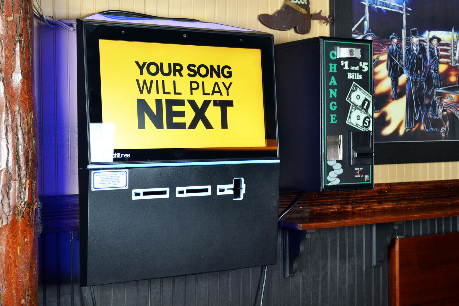 Wall-mounted TouchTunes jukebox in a bar