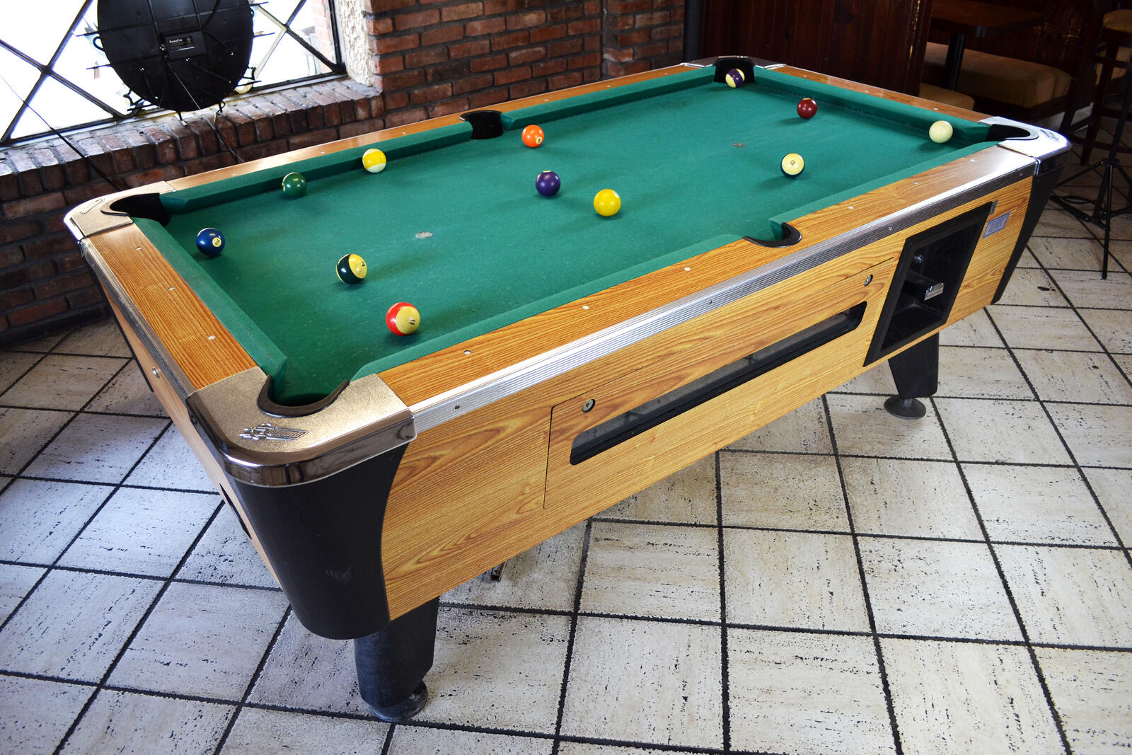Coin-operated pool table with racked balls